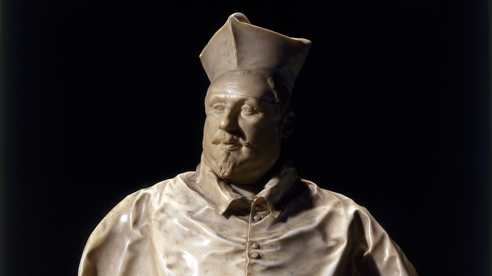 Evonne Levy Bernini Color photo of an ornate sixteenth-century bust of a man in carved stone set against a black background