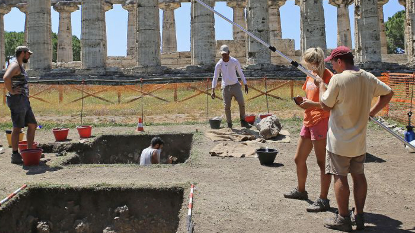 Temple Athena Color photograph of archaeologists working on a dig on a sunny day