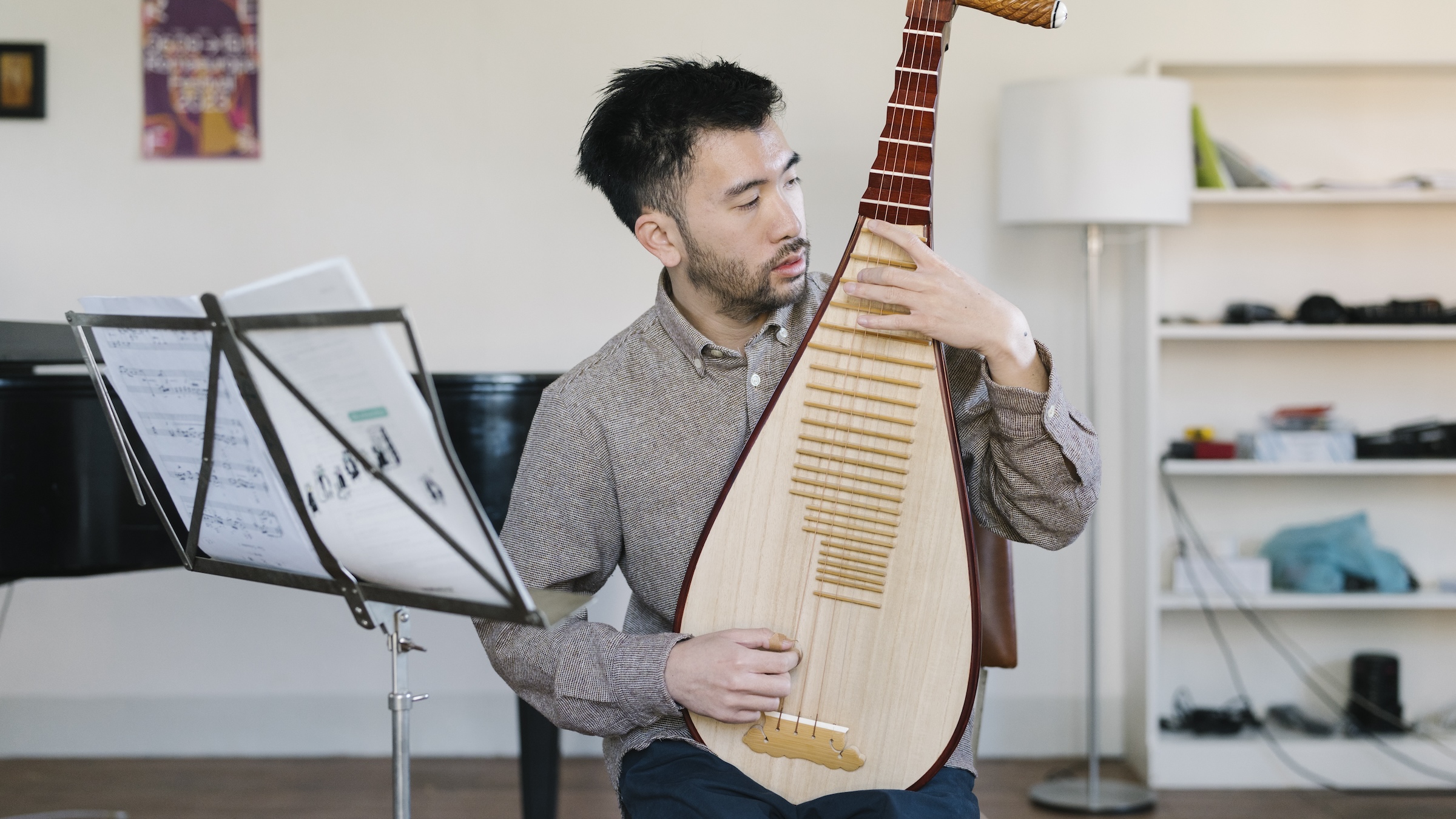 Baldwin Giang plays on a pipa.