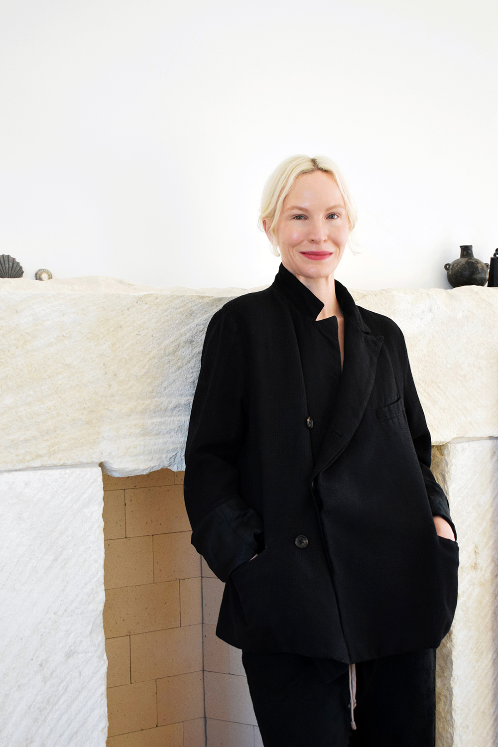 Amy Revier Color photo of a light skinned woman wearing all black and smiling at the camera