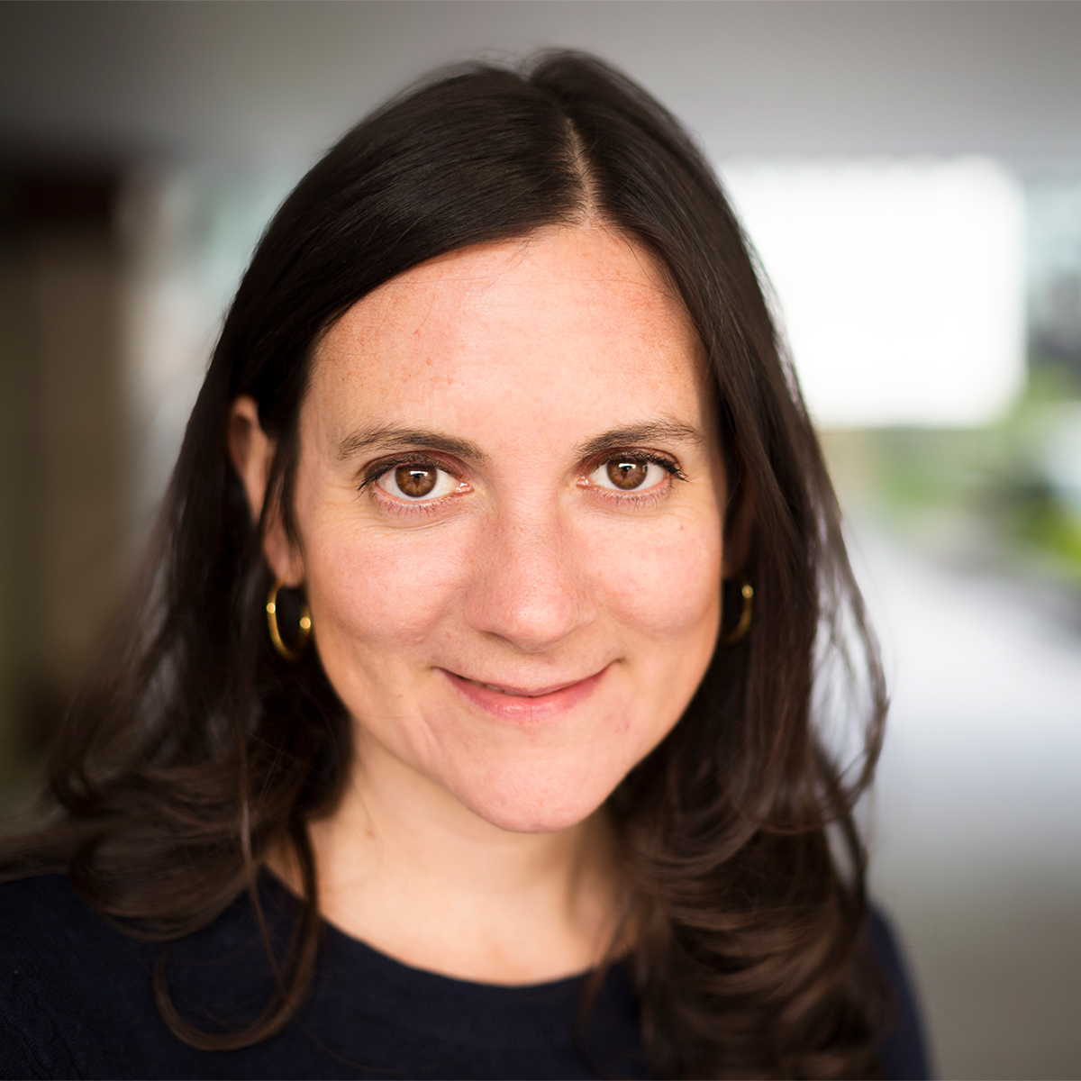 Caroline Goodson Color photo of the face of a dark haired light skinned woman smiling at the camera