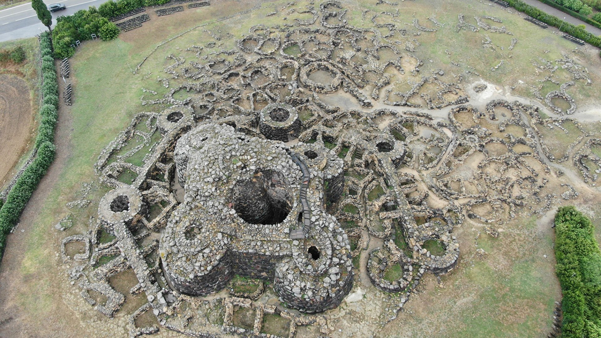Color photo of ancient ruins in a grassy field seen from above