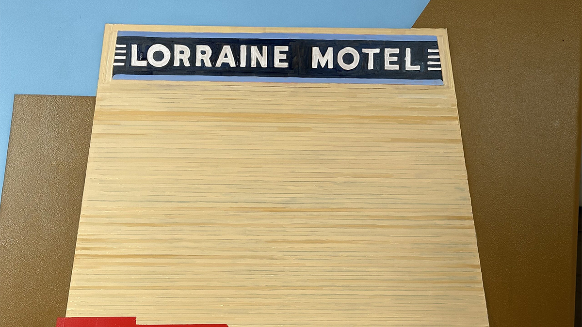 Color reproduction of a painting of a building with a sign reading Lorraine Hotel