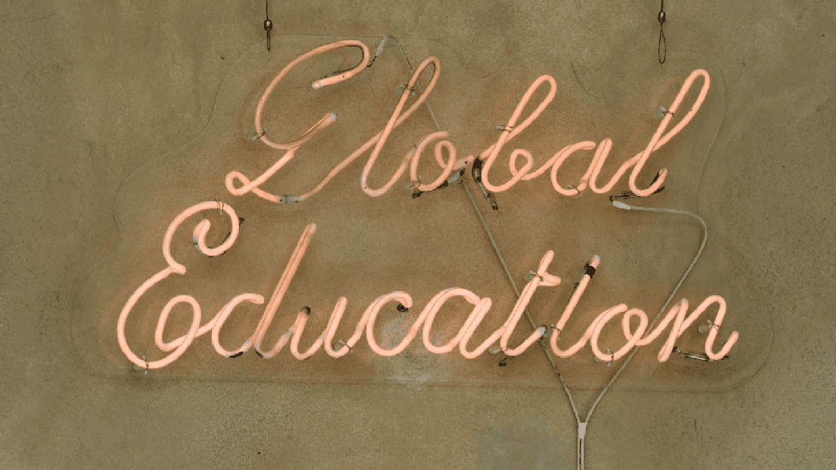 color photo of a neon wall artwork that spells &quot;Global Education&quot; in cursive writing