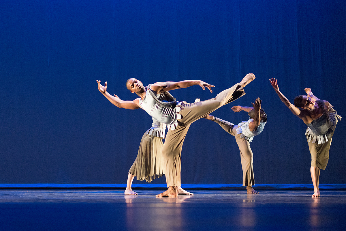Color photo of five ballet dancers onstage in various poses