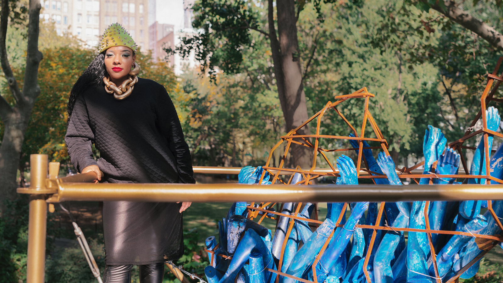 Color portrait of Abigail DeVille standing next to her outdoor public art installation at Madison Square Park