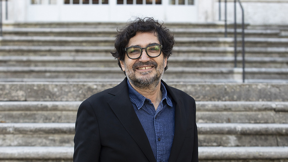 Color portrait of the head, shoulders, and chest of Avinoam Shalem, standing on the front steps of the McKim Mead &amp; White Building in Rome