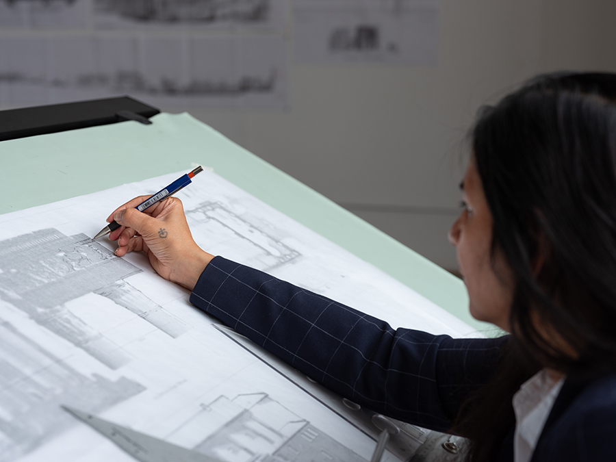 woman drawing at drafting table
