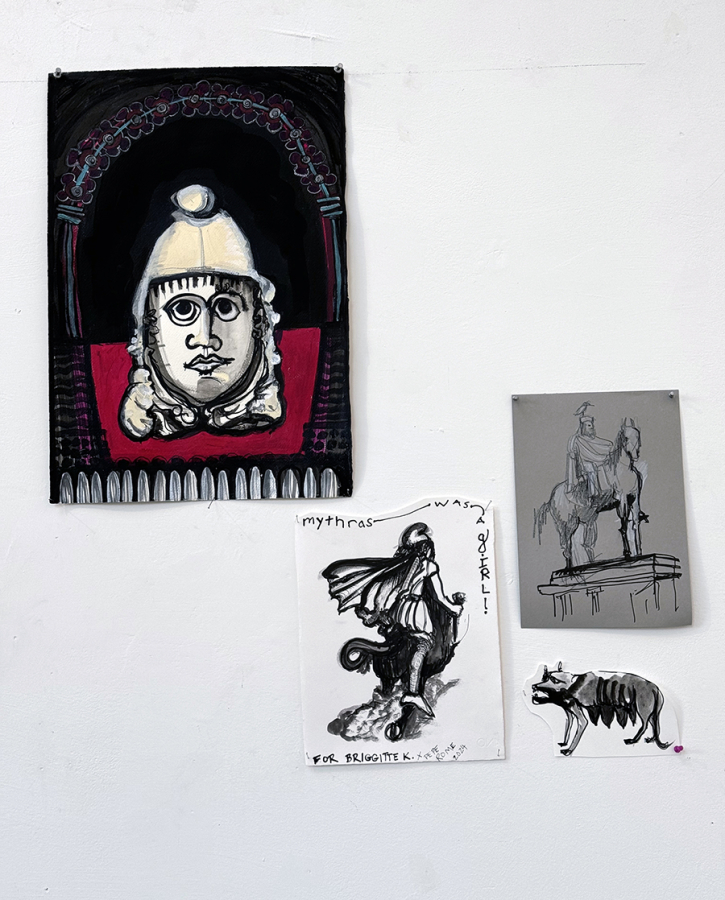 Color photo of four small drawings affixed to a white wall