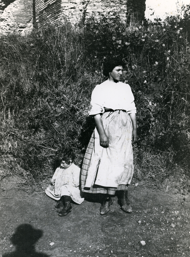 Black and white photo from mid 20th century of a woman and child in rural Italy