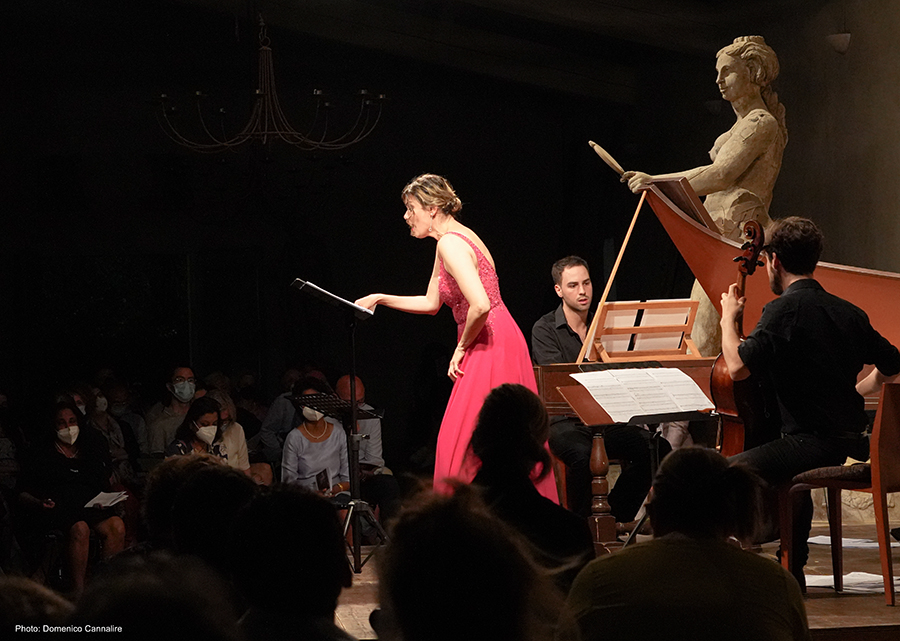 Color photograph of a conductor and classical musicians onstage