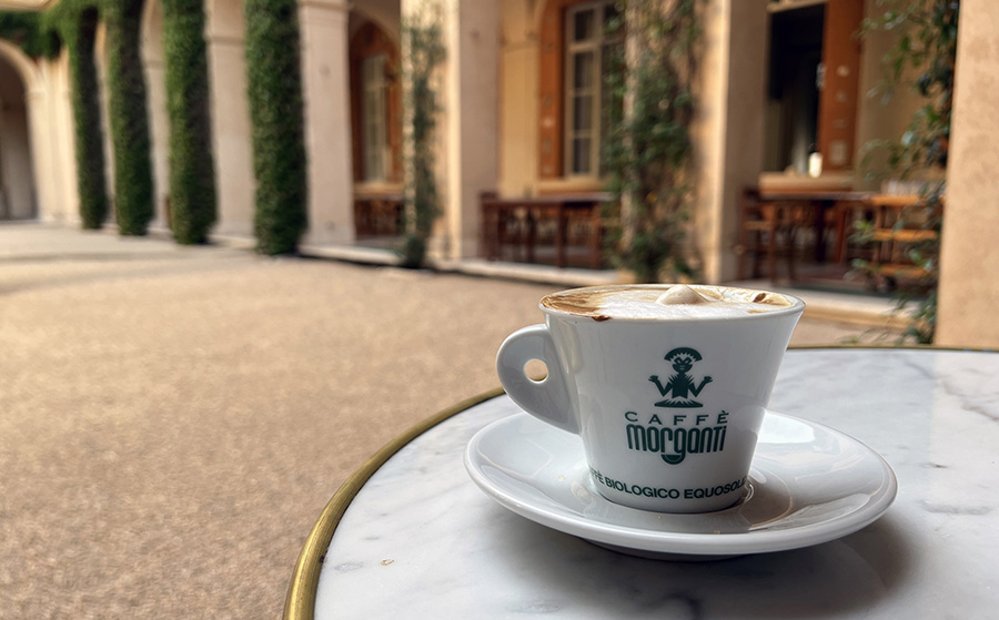 coffee cup on a table in a courtyard