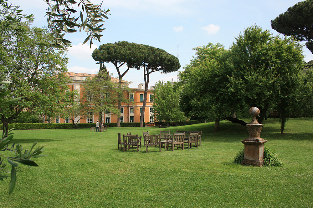 Color photograph of the Bass Garden at the American Academy in Rome, with the McKim, Mead &amp; White Building in the background
