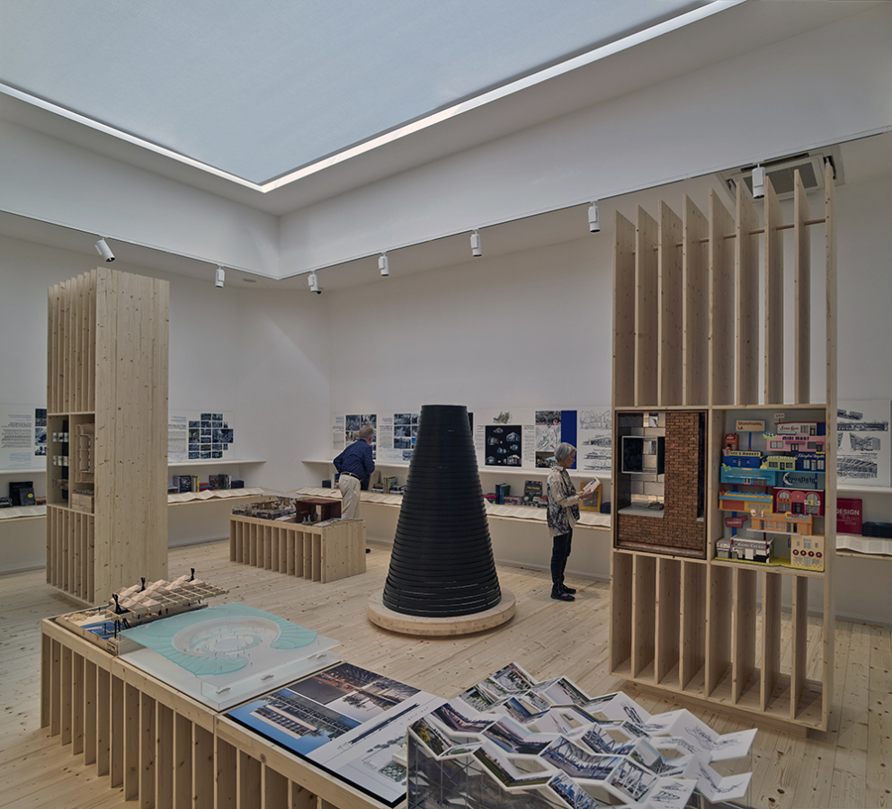 color photo of interior room showing 2d and 3d architectural projects and models