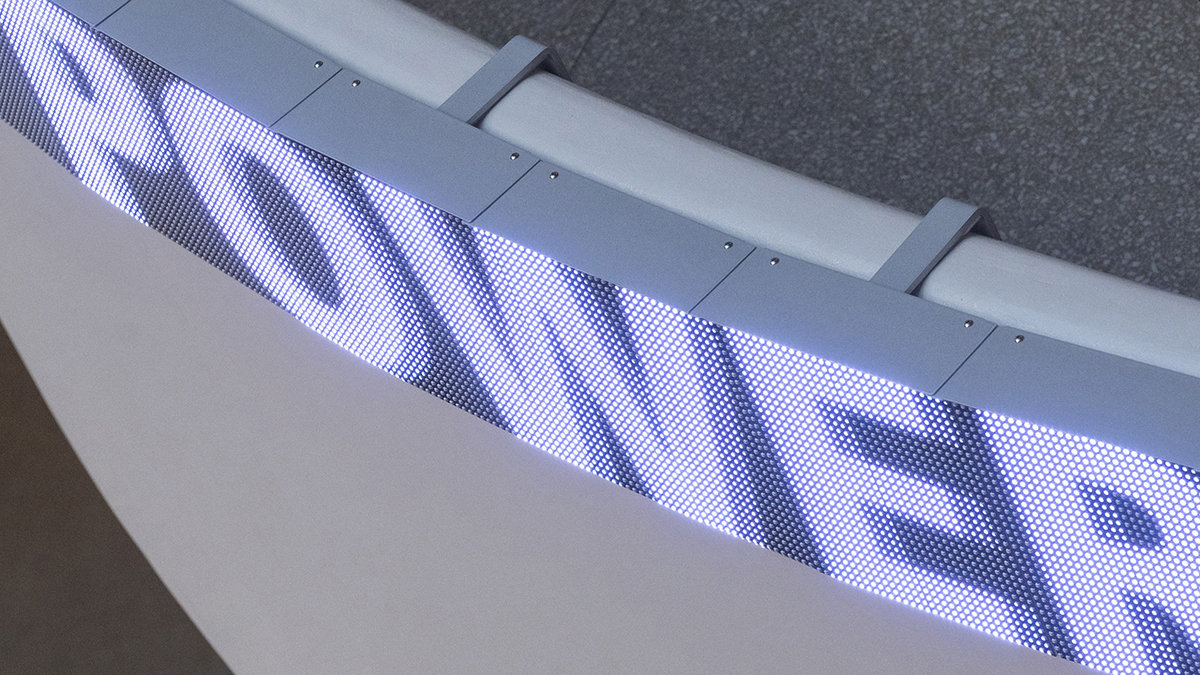 Color photoraph of an LED board with a word on it, mounted on a ledge