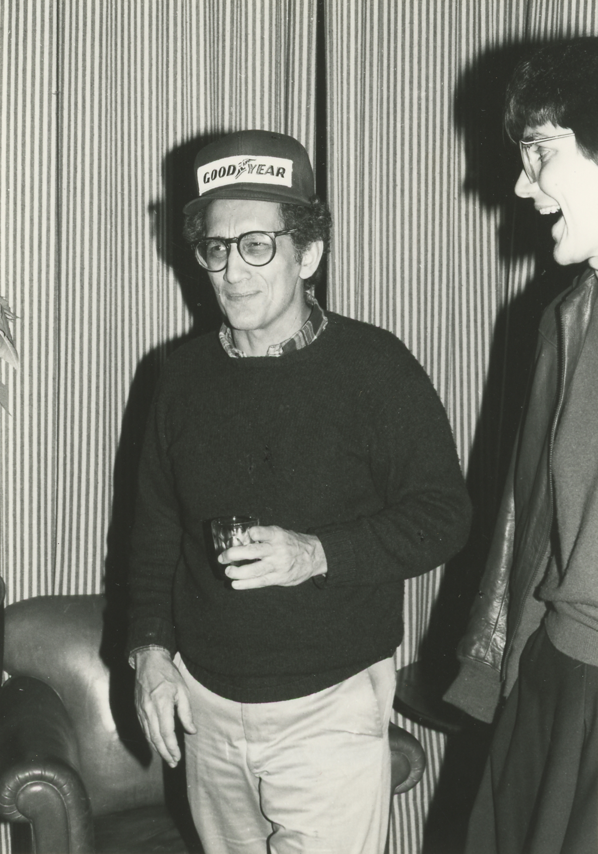 Black and white photo of a light skinned man at a party