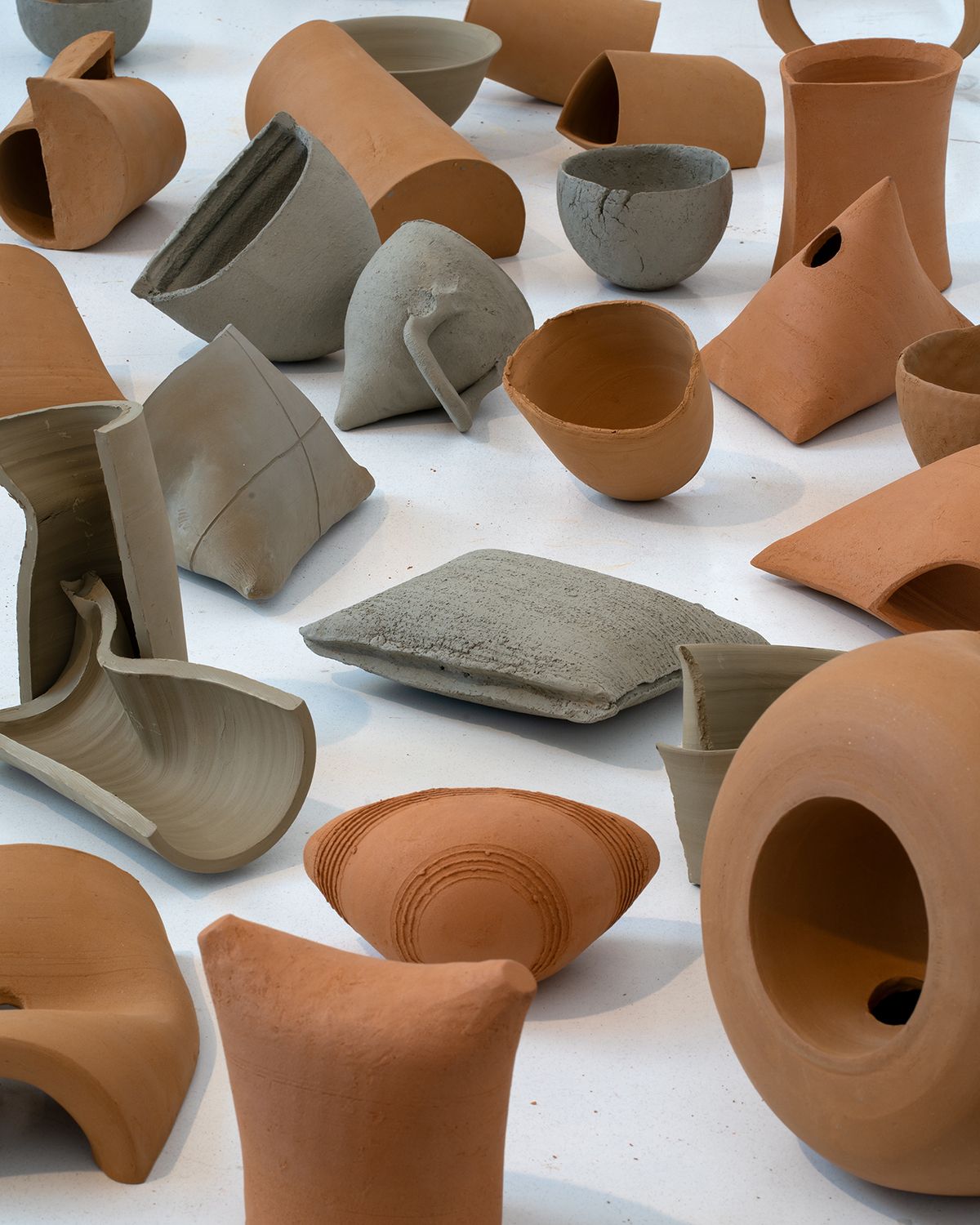 Color photograph of various terracotta vessels made from brown and gray clay