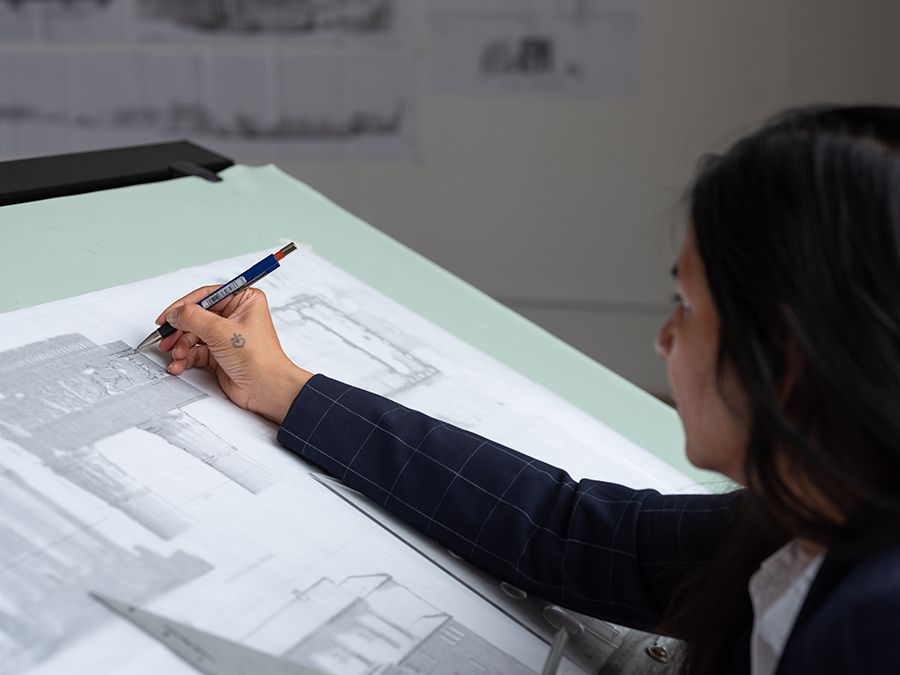 woman drawing at drafting table