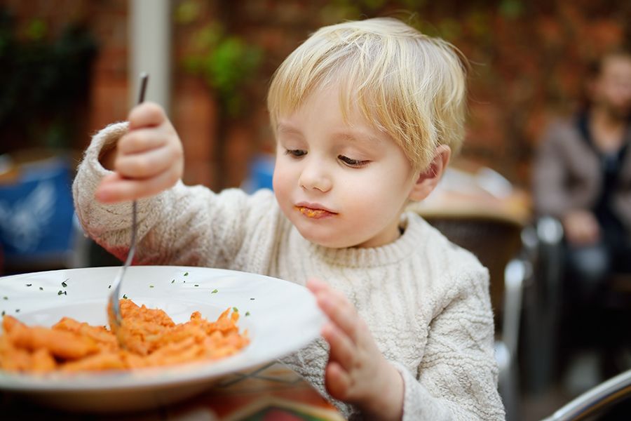 toddler eating pasta