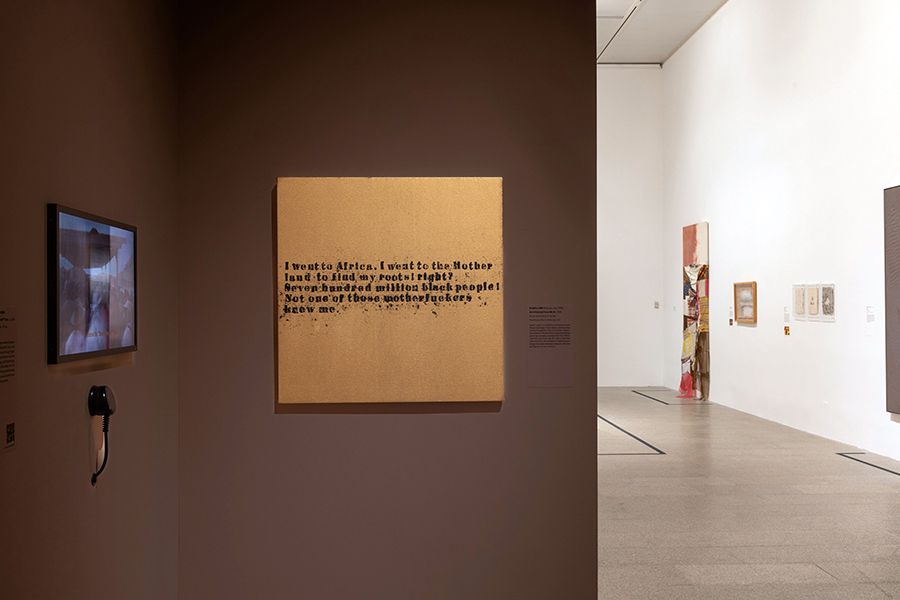 Color photo of a museum exhibition installation showing artworks on walls