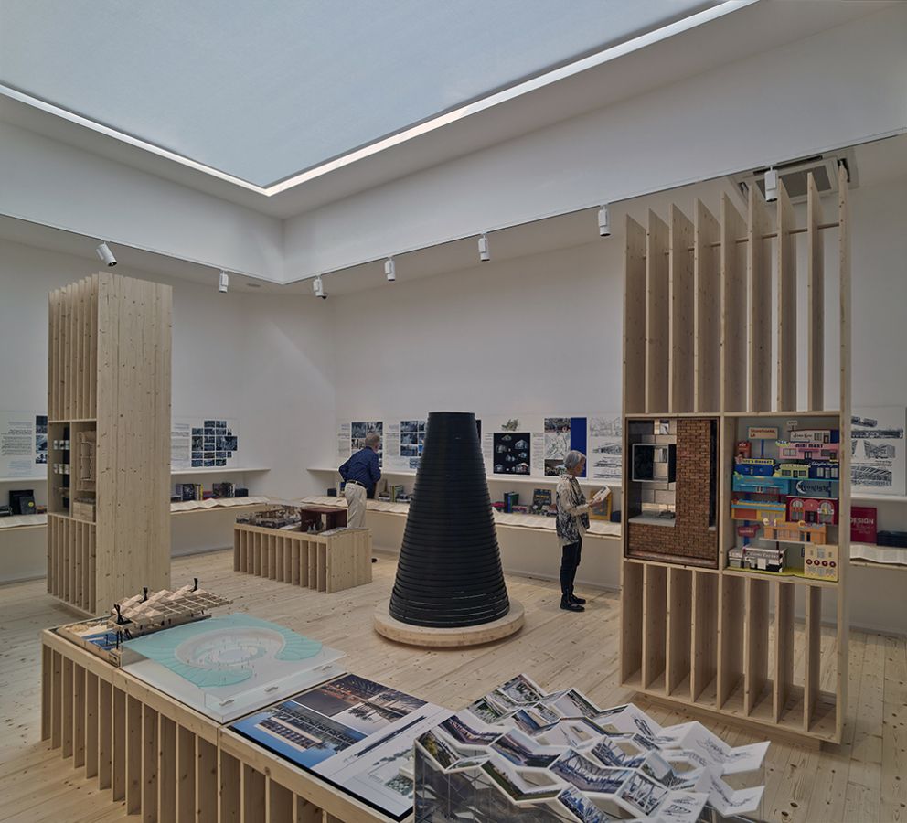 color photo of interior room showing 2d and 3d architectural projects and models