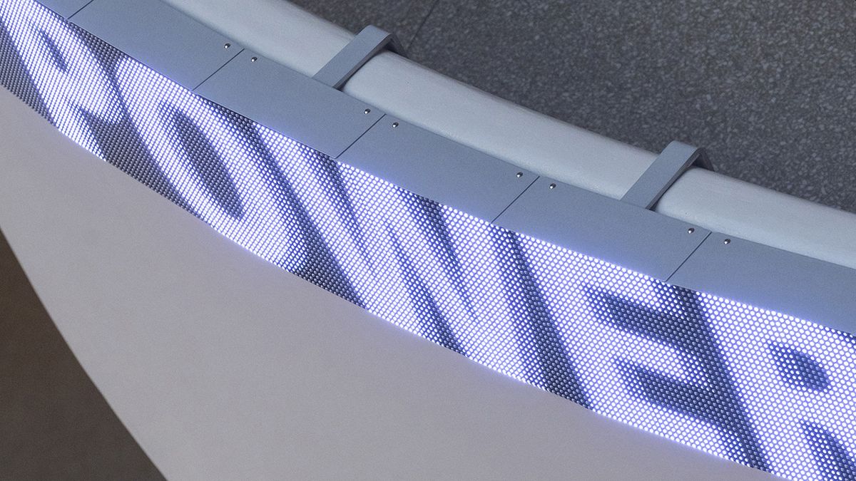 Color photoraph of an LED board with a word on it, mounted on a ledge