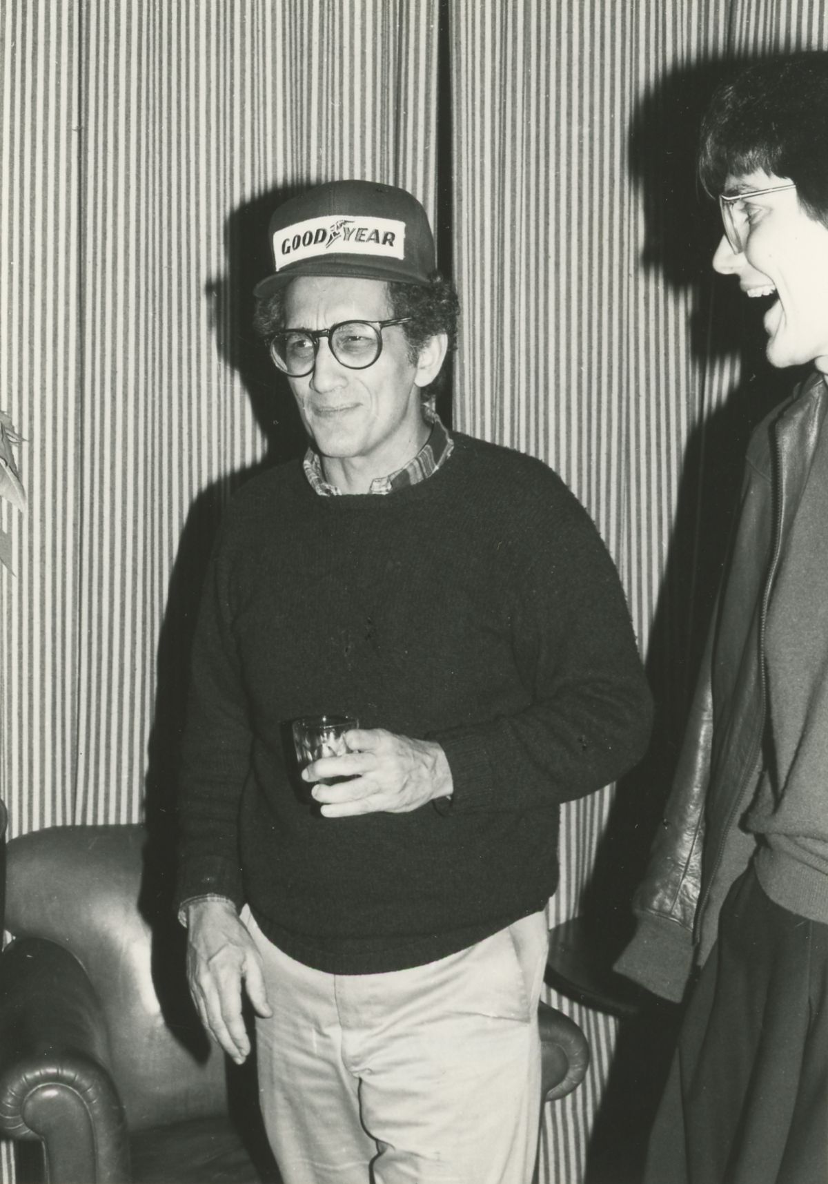 Black and white photo of a light skinned man at a party