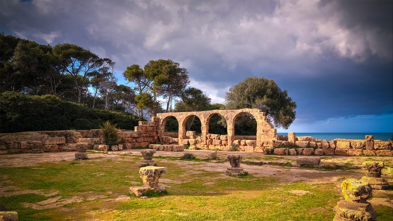Color photo of Roman ruins on a cliff by the sea
