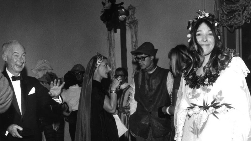 Black and white photographs of people at a party wearing costumes