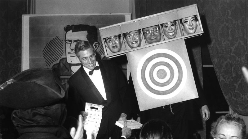 Black and white photographs of people at a party wearing costumes