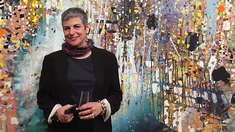 Jackie Saccoccio - standing with painting