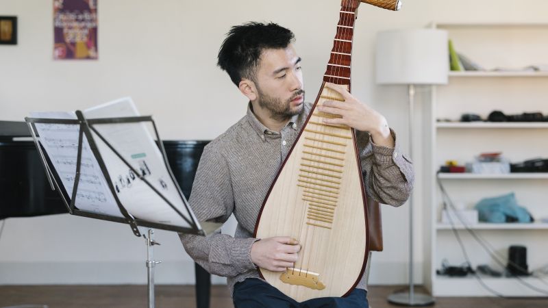 Baldwin Giang plays on a pipa.
