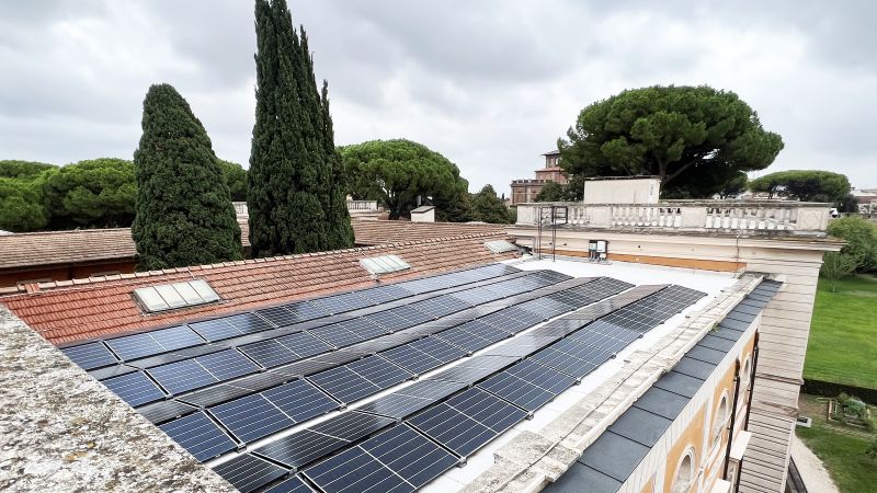 Color photographs of solar panels on a flat room, with the tops of trees in the background