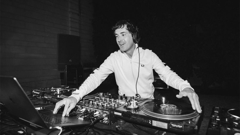 Black and white photo of a male DJ