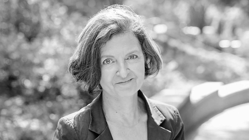 Black and white portrait of the head and shoulders of Carla Keyvanian, in an outdoor location