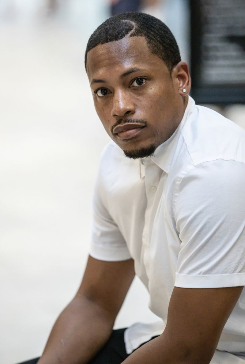 Color photograph of the head, torso, and arms of Germane Barnes, pictured in 3/4 profile and facing the camera