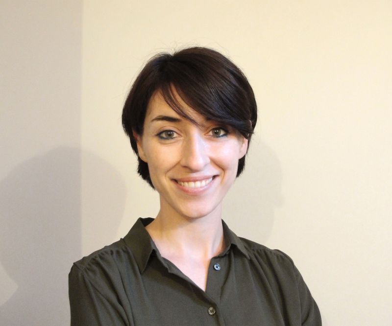 Color portrait of the head and shoulders of Giuliana Mosca, standing against a neutral white background