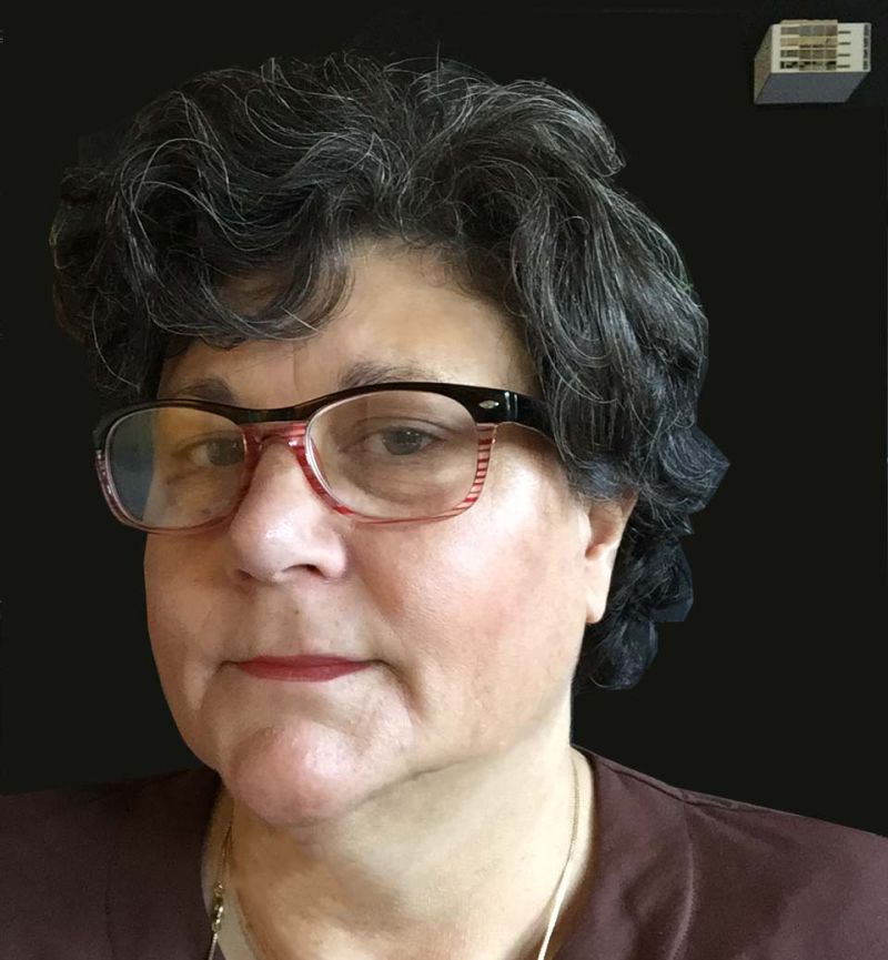 Color portrait of the head and shoulders of Paulette Marie Singley, set against a black background