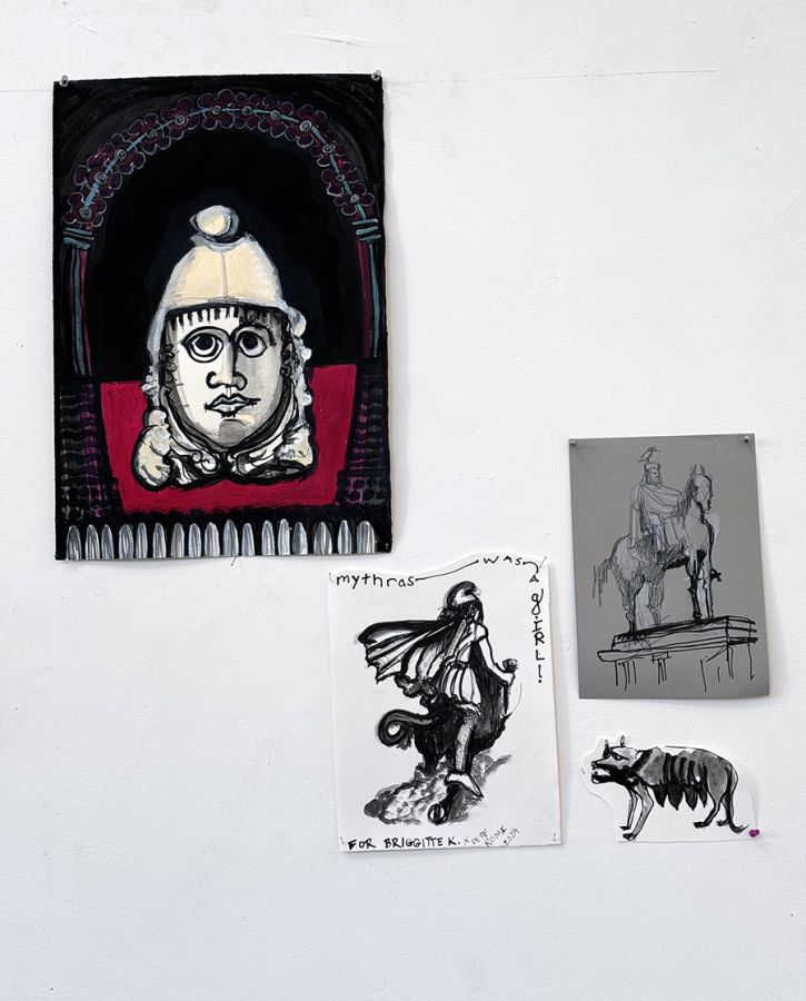 Color photo of four small drawings affixed to a white wall