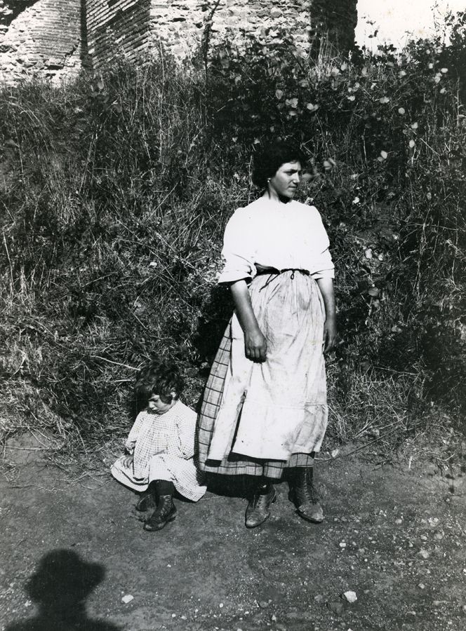 Black and white photo from mid 20th century of a woman and child in rural Italy